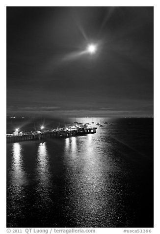 Moon and fishing pier by night. Capitola, California, USA