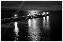 Wharf with moon reflections and light rays. Capitola, California, USA (black and white)