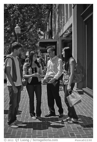 Group talking on University Avenue. Palo Alto,  California, USA (black and white)