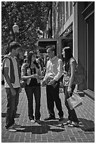 Group talking on University Avenue. Palo Alto,  California, USA ( black and white)