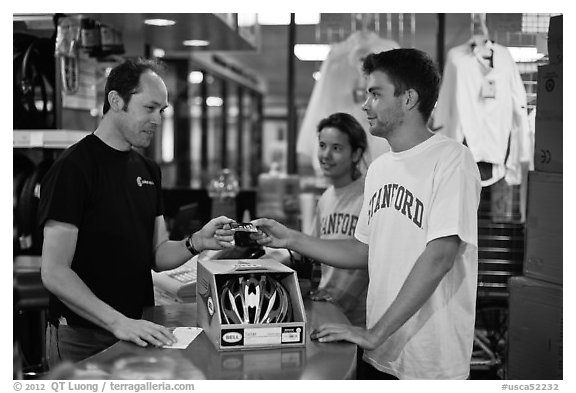 Students paying at register with credit card, Campus Bike Shop. Stanford University, California, USA (black and white)