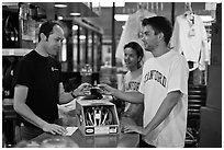 Students paying at register with credit card, Campus Bike Shop. Stanford University, California, USA ( black and white)