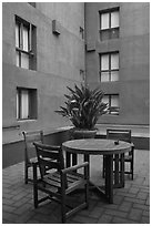 Tables and chairs in blue courtyard, Schwab Residential Center. Stanford University, California, USA ( black and white)