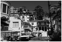 Street with hillside houses looming above, Avalon, Catalina. California, USA (black and white)