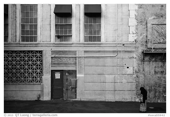 Woman standing in front of false facade, New York backlot, Paramount studios. Hollywood, Los Angeles, California, USA (black and white)
