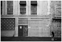 Woman standing in front of false facade, New York backlot, Paramount studios. Hollywood, Los Angeles, California, USA ( black and white)