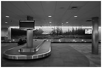 Baggage claim area and Tuolumne Meadows mural, Fresno Yosemite Airport. California, USA ( black and white)