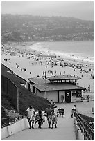 Beachgoers walking up from beach, Redondo Beach. Los Angeles, California, USA ( black and white)