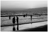 Sunset with beachgoers in water. Santa Monica, Los Angeles, California, USA ( black and white)