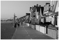 People exercising on beachfront walkway. Newport Beach, Orange County, California, USA ( black and white)