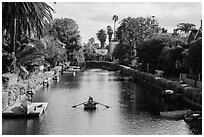 Woman rowing in canal. Venice, Los Angeles, California, USA ( black and white)