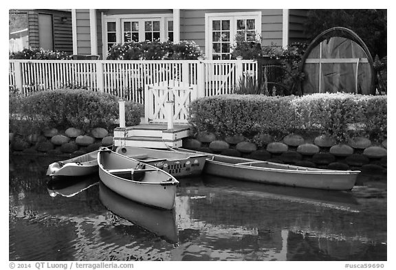 Rowboats in front of house, Venice Canal Historic District. Venice, Los Angeles, California, USA (black and white)