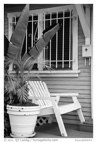 Matching white garden chair, flower pots, and window on porch. Venice, Los Angeles, California, USA (black and white)
