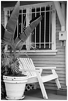 Matching white garden chair, flower pots, and window on porch. Venice, Los Angeles, California, USA ( black and white)