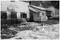 Adobe buildings and artificial flood, Universal Studios. Universal City, Los Angeles, California, USA ( black and white)