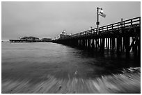 Pier and wave at dawn. Santa Barbara, California, USA ( black and white)