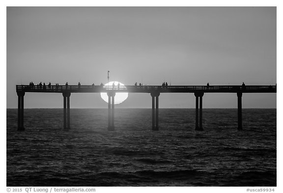 Sun setting behind Ocean Beach Pier. San Diego, California, USA (black and white)