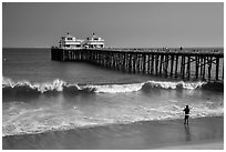 Man fishing next to Malibu Pier. Los Angeles, California, USA ( black and white)