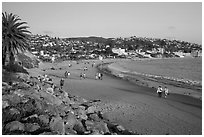 Beach with people strolling in late afternoon. Laguna Beach, Orange County, California, USA ( black and white)