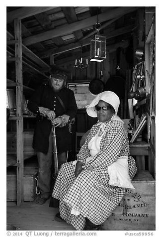 Elderly couple in period costume, Fort Tejon. California, USA (black and white)