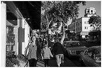 Visitors walk on sidewalk in shopping area. Laguna Beach, Orange County, California, USA ( black and white)