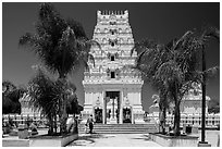 Family walks into Malibu Hindu Temple, Calabasas. Los Angeles, California, USA ( black and white)