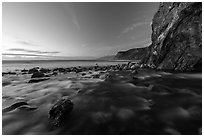 Creek, boulders, cliff, and ocean at dusk. Big Sur, California, USA ( black and white)