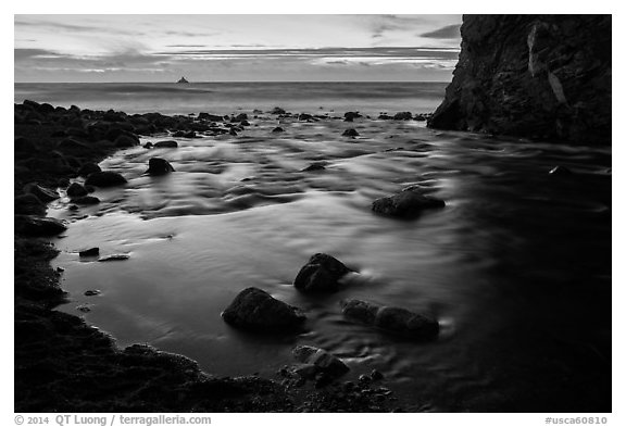 Creek flowing into ocean at dusk. Big Sur, California, USA (black and white)