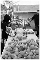 Customers buying fruit at stand. California, USA ( black and white)