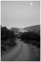 Road at dusk and moon. California, USA ( black and white)