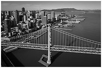 Aerial view of Bay Bridge, downtown, and piers. San Francisco, California, USA ( black and white)
