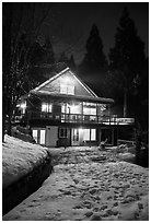 Cabin with window lights in winter. California, USA ( black and white)