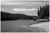 Family on shore of Jenkinson Lake, Pollock Pines. California, USA ( black and white)
