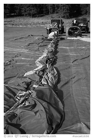 Hot air balloon being folded for transportation, Tahoe National Forest. California, USA (black and white)