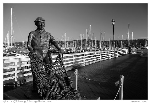 Statue of fisherman on wharf. Monterey, California, USA (black and white)