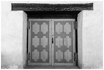 Decorated wooden door, Mission San Miguel. California, USA ( black and white)