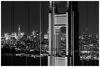 Golden Gate Bridge pillar and San Francisco skyline at night. San Francisco, California, USA ( black and white)