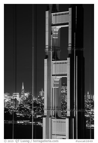 Golden Gate Bridge pillar and city skyline at night. San Francisco, California, USA (black and white)