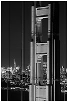 Golden Gate Bridge pillar and city skyline at night. San Francisco, California, USA ( black and white)