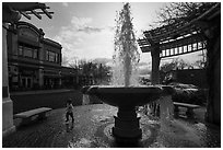 Fountain and plaza with child playing. Livermore, California, USA ( black and white)
