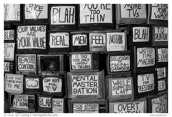 Wall of televisions covered with slogans, Slab City. Nyland, California, USA (black and white)