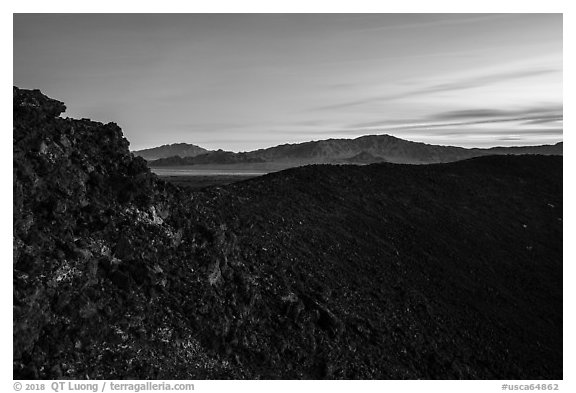 Rim of Amboy Crater and mountains at dusk. Mojave Trails National Monument, California, USA (black and white)