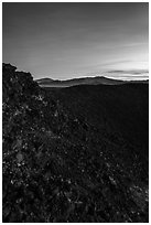 Interior slopes of Amboy Crater and mountains at dusk. Mojave Trails National Monument, California, USA ( black and white)
