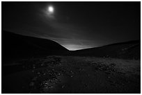 Moon shining inside Amboy Crater at night. Mojave Trails National Monument, California, USA ( black and white)