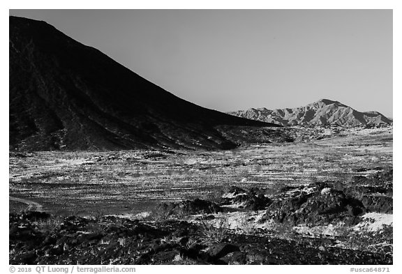 Lava field, Amboy Crater slope and mountains. Mojave Trails National Monument, California, USA (black and white)