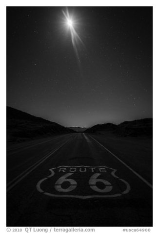 Route 66 marking and moon at night. Mojave Trails National Monument, California, USA (black and white)
