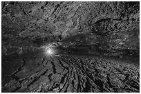 Golden Dome Cave with caver's light. Lava Beds National Monument, California, USA ( black and white)