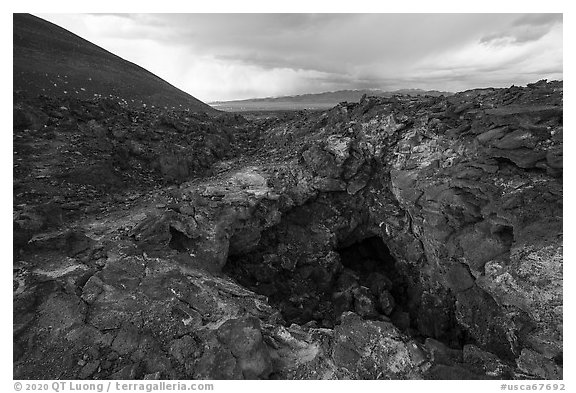Pisgah Cinder cone and entrance to lava tube cave. Mojave Trails National Monument, California, USA (black and white)