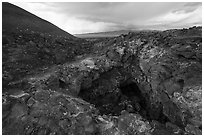 Pisgah Cinder cone and entrance to lava tube cave. Mojave Trails National Monument, California, USA ( black and white)