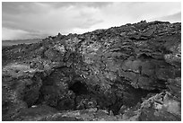 Depression and entrance to lava tube cave. Mojave Trails National Monument, California, USA ( black and white)
